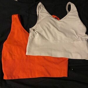 Orange and white athletic tanks size m